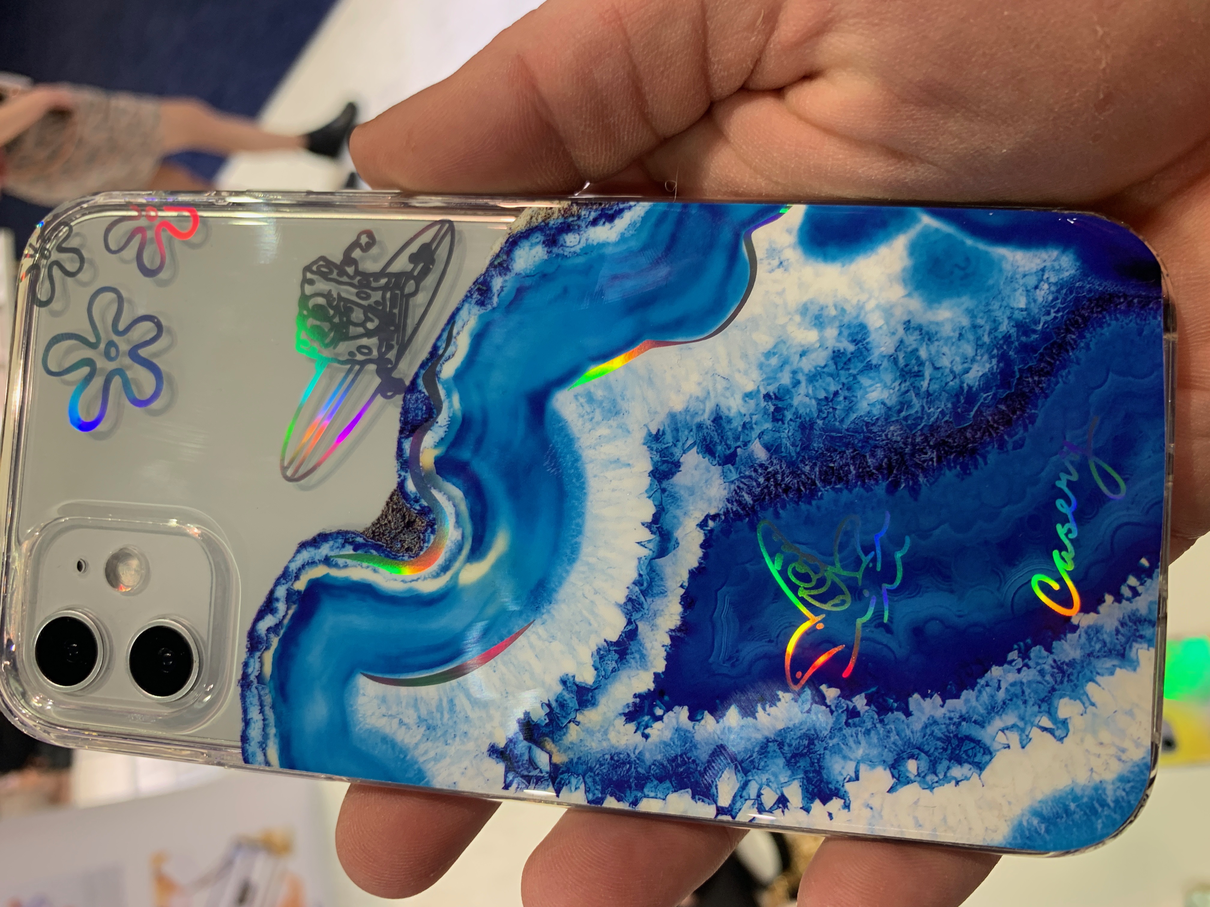 Casery phone case with blue agate pattern and holographic SpongeBob stickers